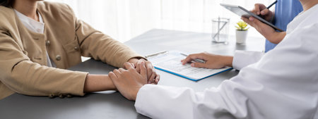 Doctor show medical diagnosis report and providing compassionate healthcare consultation while holding young patient hand for being supportive and professional in doctor clinic office. Neotericの写真素材
