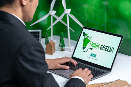 Businessman working in office developing plan or project on eco-friendly alternative energy with solar cell technology display on computer screen for greener environment as apart of CSR effort. Gyreの写真素材