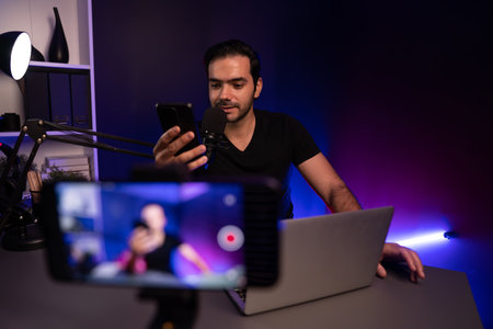 Broadcaster talking to listener on live streaming online with blurred screen, reading comment on...