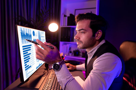 Smart businessman pointing with pen on desk to focusing research target market in service product...