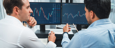 Stock exchange traders discussing on market stock comparing with two screen in chart on panorama...