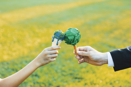 Businessman exchange tree to a boy holding melting Earth as part of ESG and CSR initiative concept...
