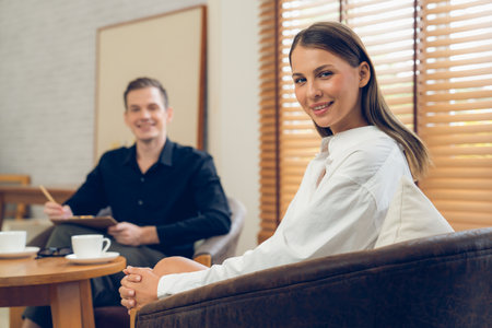 Psychological consultation gaining improvement on mental problem, happy young female patient doing therapy session while psychiatrist making diagnostic on mental illness. Unveilingの写真素材