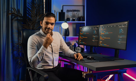 Profiles smart IT developer looking camera to pose with against on software development coding on pc...