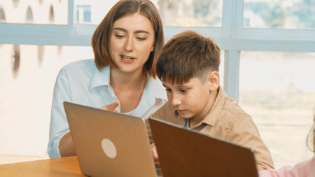 Smart boy coding program or learning prompt at STEM technology class. Caucasian student study about...