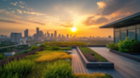 This blurred image captures the essence of a sunset over a city skyline, viewed from a lush rooftop garden with a serene ambiance. Resplendent.の写真素材