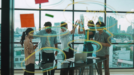 Group of professional happy business team high five with colleagues at table. City view. Diverse...