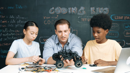 Smart teacher inspect car model construction to diverse student. Highschool children with mixed...