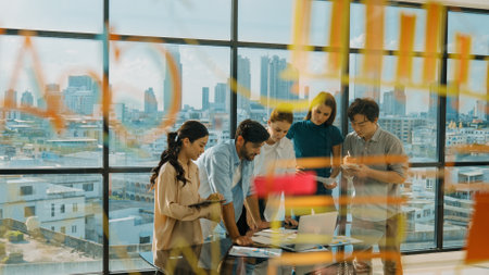 Group of diverse business people brainstorming about marketing plan. Multicultural business team working, talking, presenting about financial strategy with idea written on glass wall. Traceryの写真素材