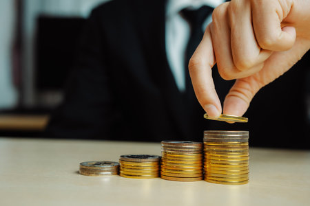 Businessman working with coin money currency. Concept of investment growth and money saving. udsの写真素材