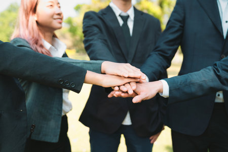 Eco business people join hand together as teamwork and unity, outdoor business volunteer mission for eco-friendly practices and collaboration in corporate social responsibility for environment. Gyreの写真素材
