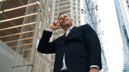 Low angle camera view of businessman calling to manager while discuss about business plan with...