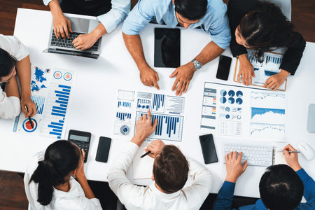Top view analyst team utilizing BI Fintech to analyze financial data at table in meeting room. Analytic BI dashboard power on paper for business insight and strategic marketing planning. Prudentの写真素材