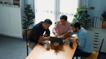 Top view of smart business team looking at laptop while analyzing marketing data and financial graph or stock market chart and make a decision for investment at meeting with sticky notes. Convocation.の写真素材