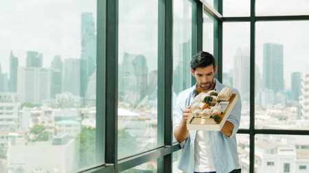 Businessman in casual outfit holding house model while checking house construction. Architect...