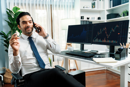 Trader businessman calling to consultant or partner with two stock exchange investment, compare data analysis to invest high profit value dynamic financial technology stock market at office. Surmise.の写真素材