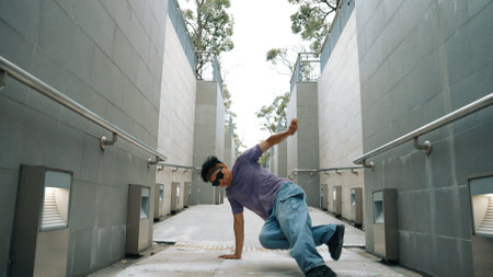 Professional break dancer perform street dance at narrow corridor. Skilled happy asian hipster...