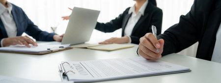 Two business executive in boardroom discuss term and company merging agreement, review corporate contract document as business partnership and cooperation with acquisition and merger concept. Shrewdの写真素材