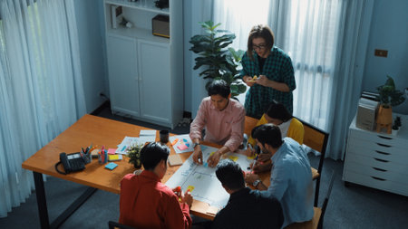 Close up of professional business team hands writing and putting sticky note on scrum task board....