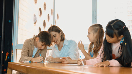 Panorama shot of happy diverse student and smart teacher drawing and coloring by using marker at drawing book. Multicultural learner using drawing book together at art lesson. Relaxation. Erudition.の写真素材