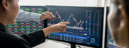 Group of skilled investor discuss about stock investment. Businesspeople look at stock charts before...