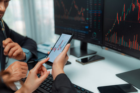 Focusing on phone with discussing dynamic stock market in two business traders online website...