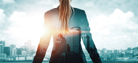 Double Exposure Image of Business Person on modern city background. Future business and communication technology concept. Surreal futuristic cityscape and abstract multiple exposure interface. udsの写真素材