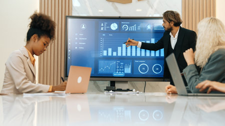 Presentation in office or ornament meeting room with analyst team utilize BI Fintech to analyze financial data. Businesspeople analyzing BI dashboard power display on TV screen for strategic planningの写真素材