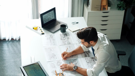 Architect engineer using laptop planning house design at office while sitting at meeting table with...