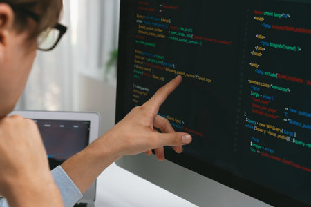 IT developer selecting by point on coding online software development information on pc comparing...
