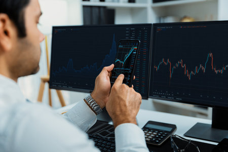 Trader businessman searching on smartphone, analyzing in dynamic stock exchange investment screen on...