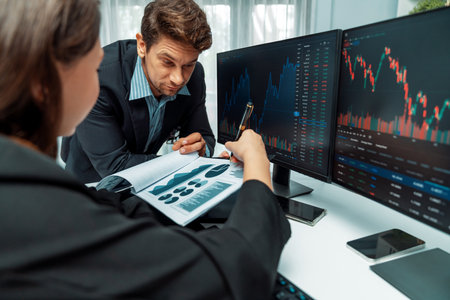 Two business traders discussing value business statistic graph company on paper report analyzing...