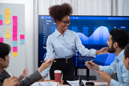 Young african businesswoman presenting data analysis dashboard on TV screen in modern meeting....