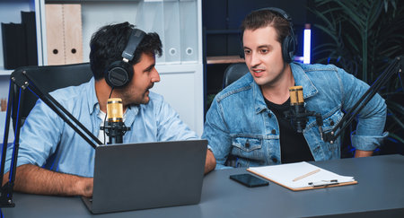 Host channel of smart influence broadcaster talking with new special guest at modern studio, streaming online greeting with listeners on social media live or radio. Concept of giving advice. Sellable.の写真素材