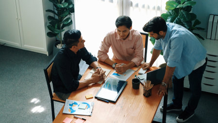 Group of diverse people sharing idea while writing at sticky notes. Professional smart business team brainstorming idea and planning strategy for startup project while wear casual outfit. Convocation.の写真素材