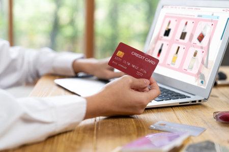 Woman shopping online on internet marketplace browsing for sale items for modern lifestyle and use credit card for online payment from wallet protected by uttermost cyber security softwareの写真素材