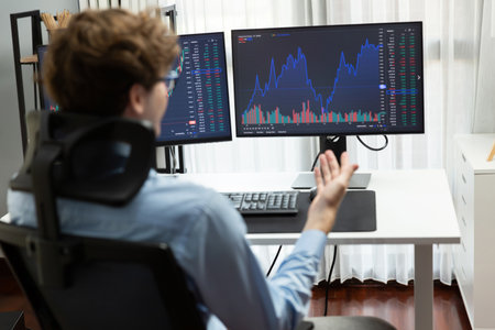 Young investor stock trader calling on smartphone to broker, discussing with dynamic financial...