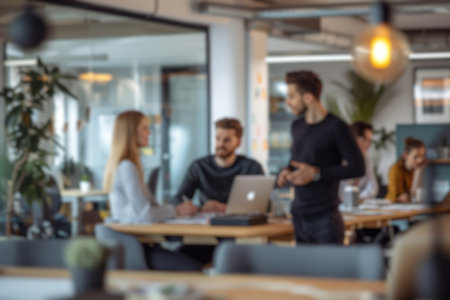 Blurred photo capturing the dynamic atmosphere of a modern open-plan office with people engaged in...