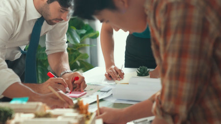 Close up of smart business team hand working together to plan design while looking at project plan from tablet and discussing about blueprint and building construction at meeting table. Alimentation.の写真素材