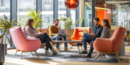 Blurred photo capturing the dynamic atmosphere of a modern open-plan office with people engaged in discussion and work. Resplendent.の写真素材