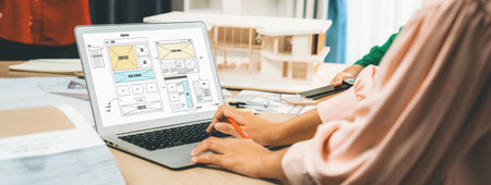 Cropped image of interior designer team discuss the material color while laptop displayed website...