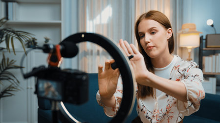 Woman influencer shoot live streaming vlog video review skincare for prim social media or blog. Happy young girl with cosmetics studio lighting for marketing recording session broadcasting online.の写真素材