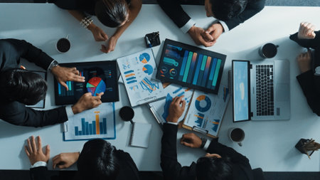 Top down aerial view of smart business man join meeting and present financial plan while diverse business people discuss and brainstorm marketing idea at table with marketing document. Directorate.の写真素材