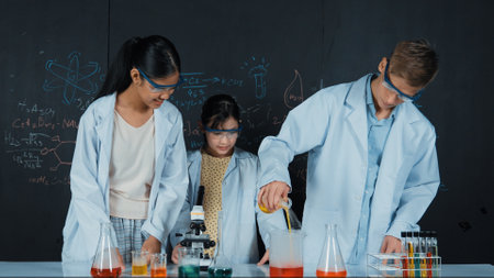 Smart girl pour colored solution in to beaker while diverse student excited about doing experiment....