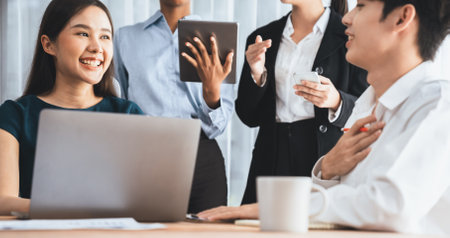 Happy diverse business people work together, discussing in corporate office. Professional and...