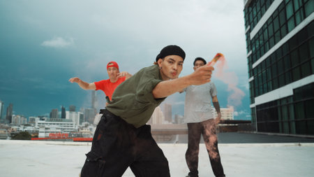 Group of multicultural hipster playing color flare at rooftop. Attractive street dancer holding colored smoke and perform break dance move to hip-hop music. Outdoor sport 2024. Endeavor.の写真素材