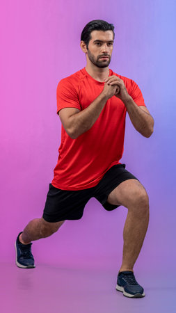 Full body length gaiety shot athletic and sporty young man with fitness in squat exercise posture on isolated background. Healthy active and body care lifestyle.の写真素材
