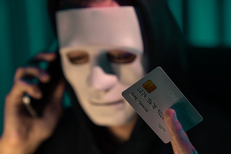 White criminal anonymous mask calling to credit card owner to threaten ransom with privacy information all database, making password encryption by programming hack trying to make insecure. Pecuniary.の写真素材