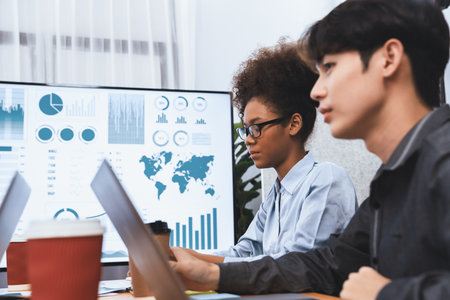 Young asian businesswoman presenting data analysis dashboard on TV screen in modern meeting. Business presentation with group of business people in conference room. Concordの写真素材