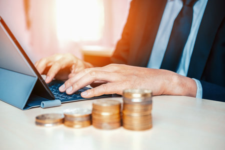 Businessman working with coin money currency. Concept of investment growth and money saving. udsの写真素材